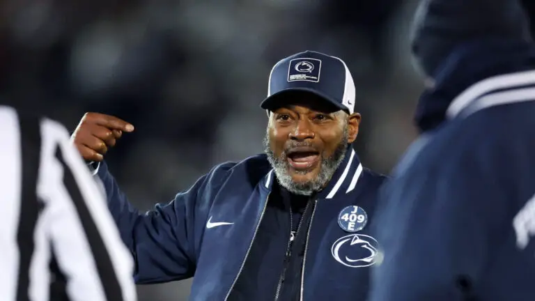 Terry Smith coaching on the Penn State sideline after the Nebraska win, drawing support from players and fans.