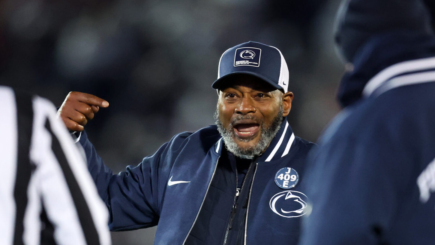 Terry Smith coaching on the Penn State sideline after the Nebraska win, drawing support from players and fans.